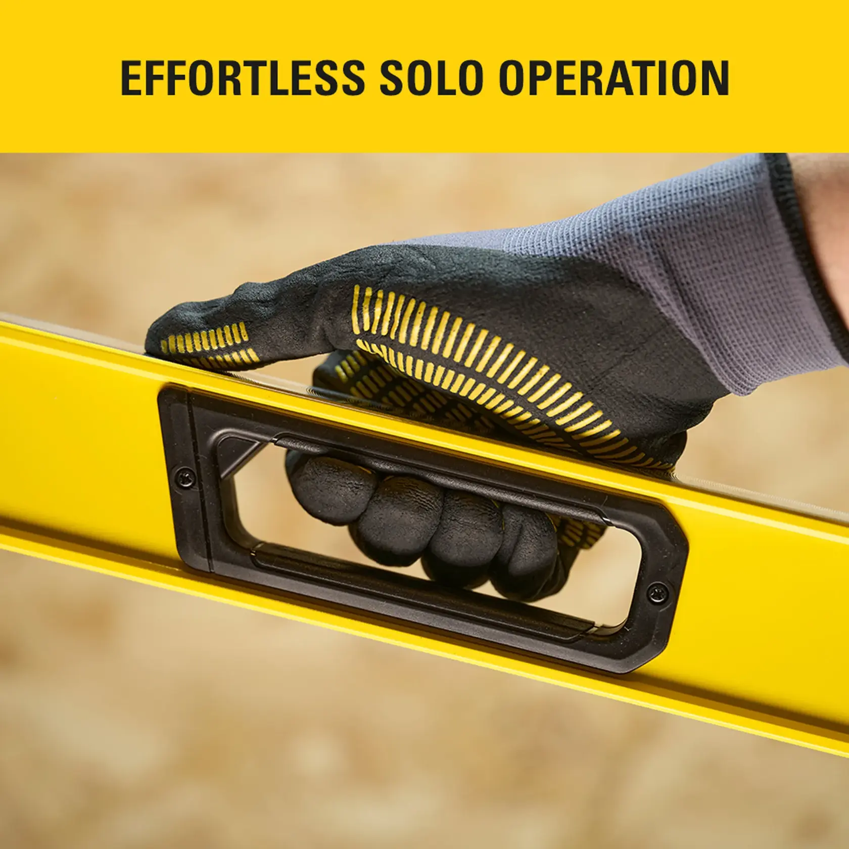 Photo of STANLEY STHT41048-0 graphics showing a gloved hand holding a yellow level tool by its handle.
