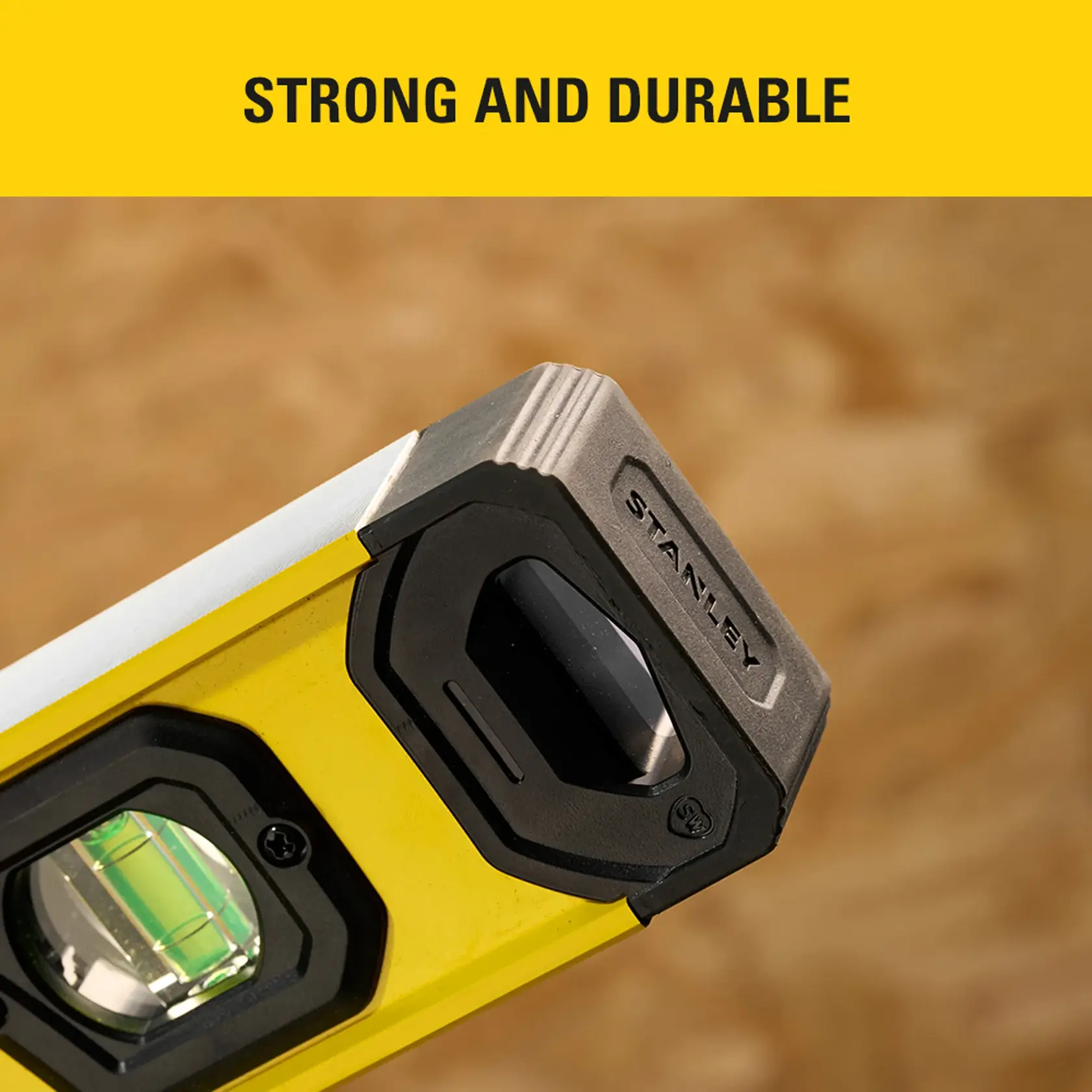 Photo of STANLEY SKHU STHT41724-0 graphics, close up of yellow level tool corner with durable end cap.