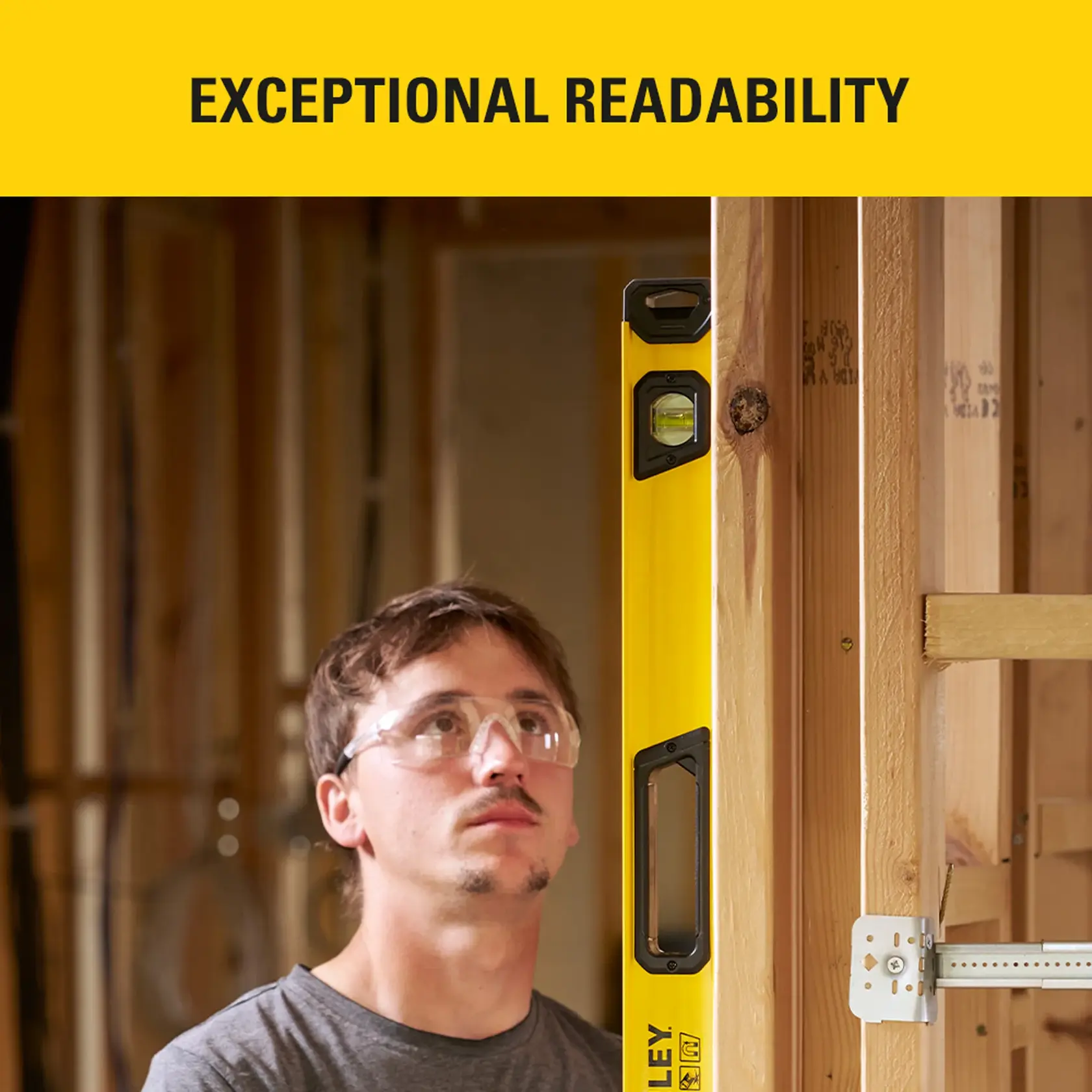 Photo of STANLEY STHT41748-0 level tool in use against wood frame, highlighting readability feature.