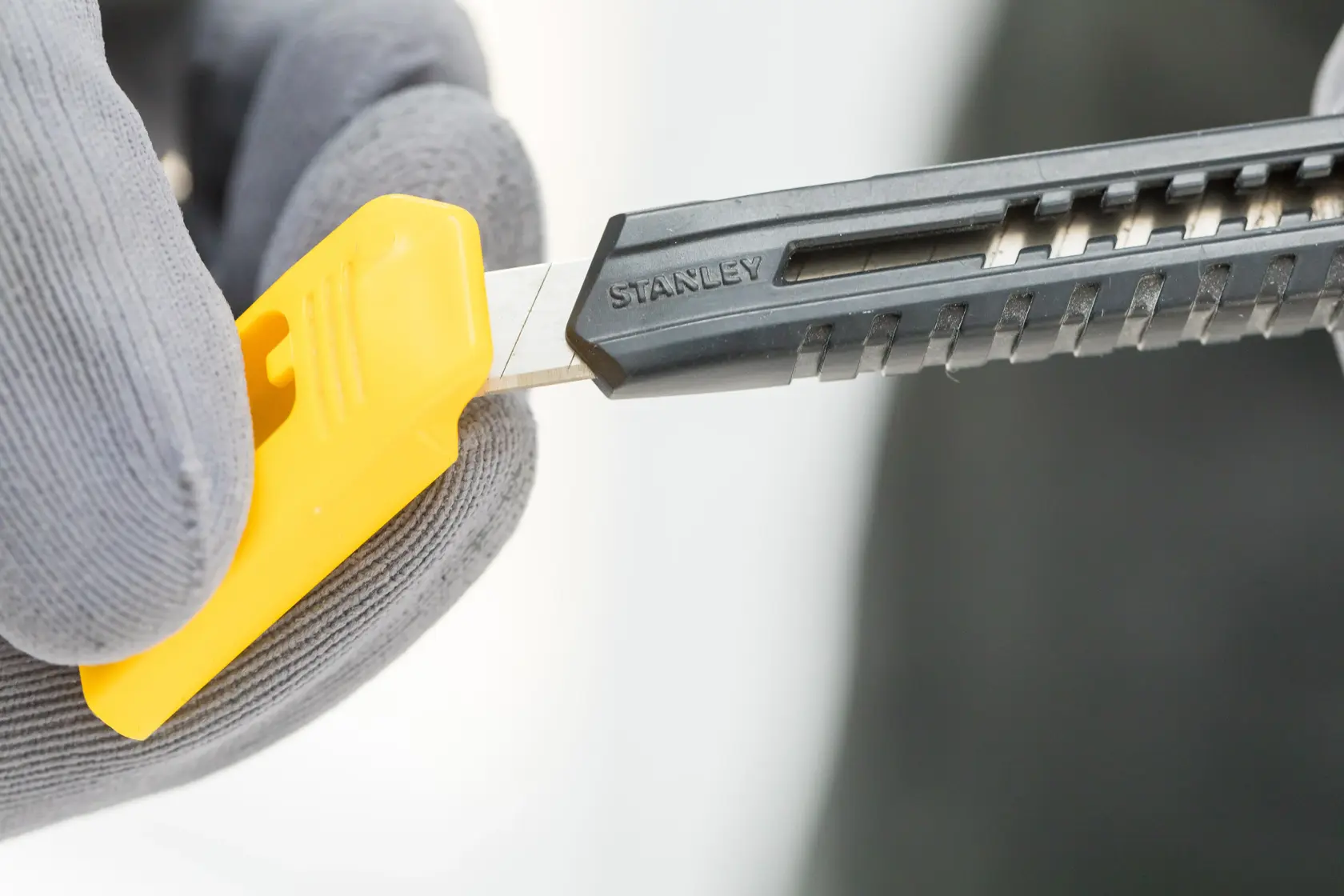 STANLEY 0-10-150 utility knife with yellow and black body, side view on white background.