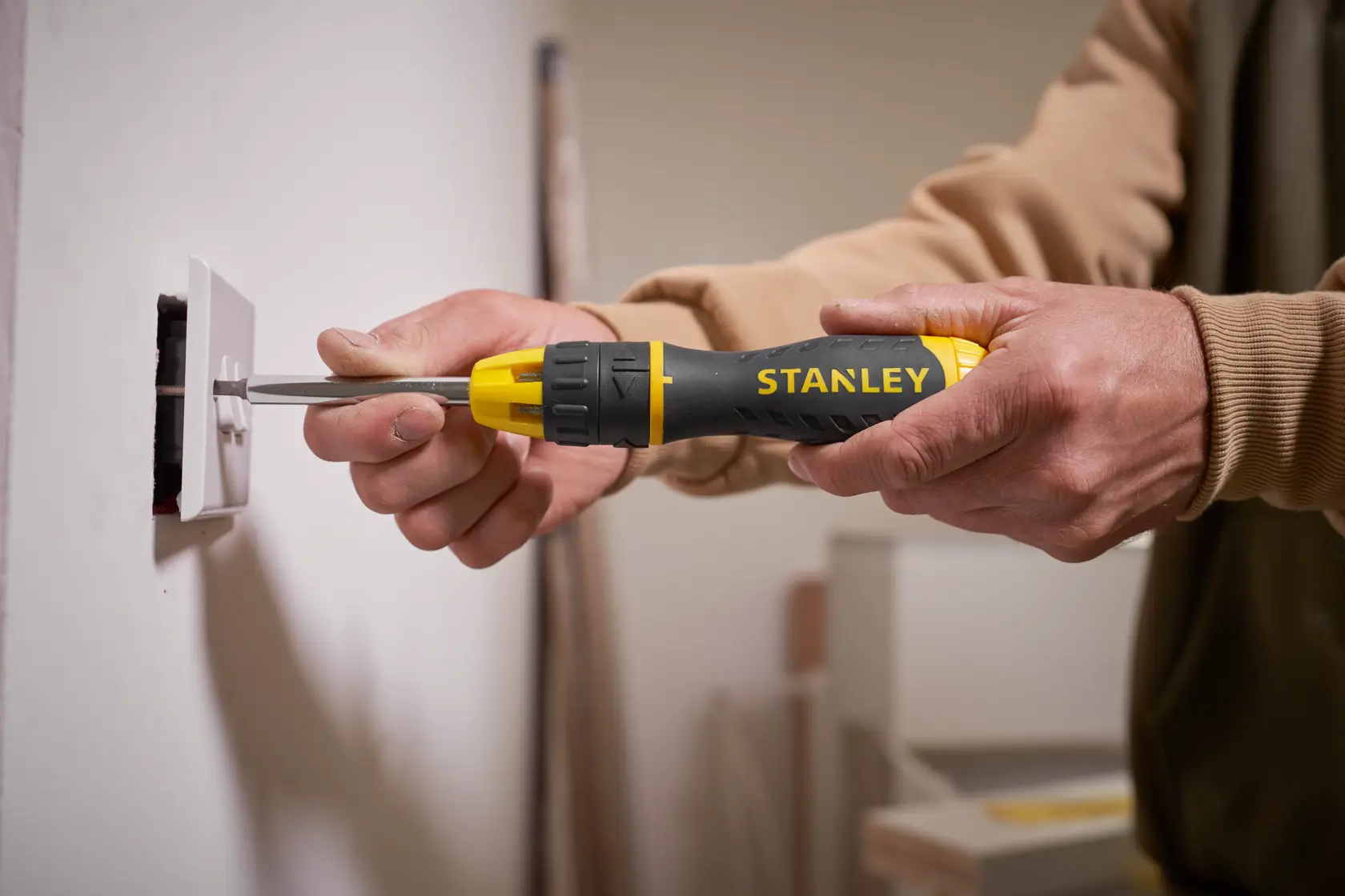 Photo of STANLEY 0-68-010 screwdriver used to install a wall outlet, close-up view.