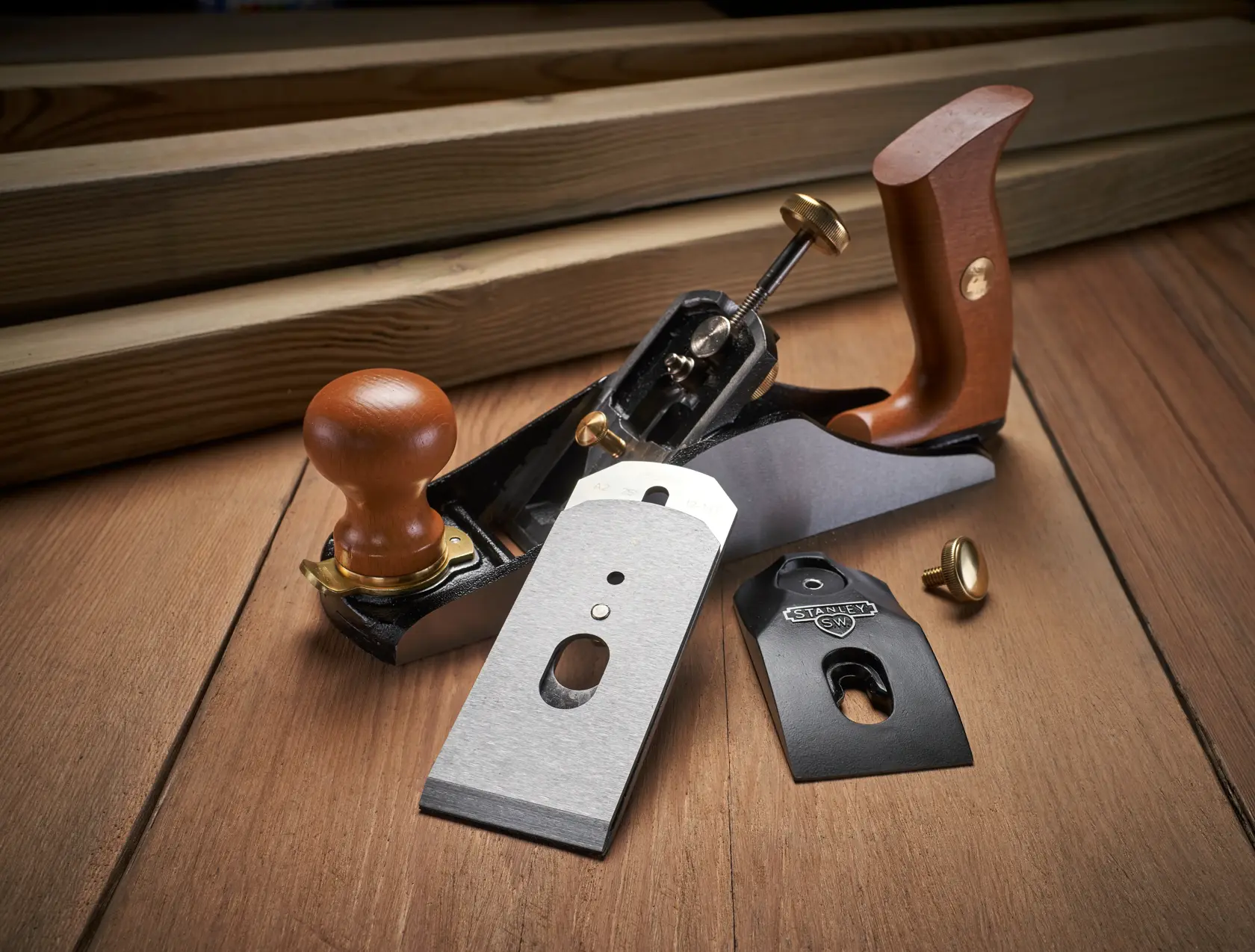 Photo of STANLEY 1-12-136 hand plane with wood handles and disassembled blades on wood surface.