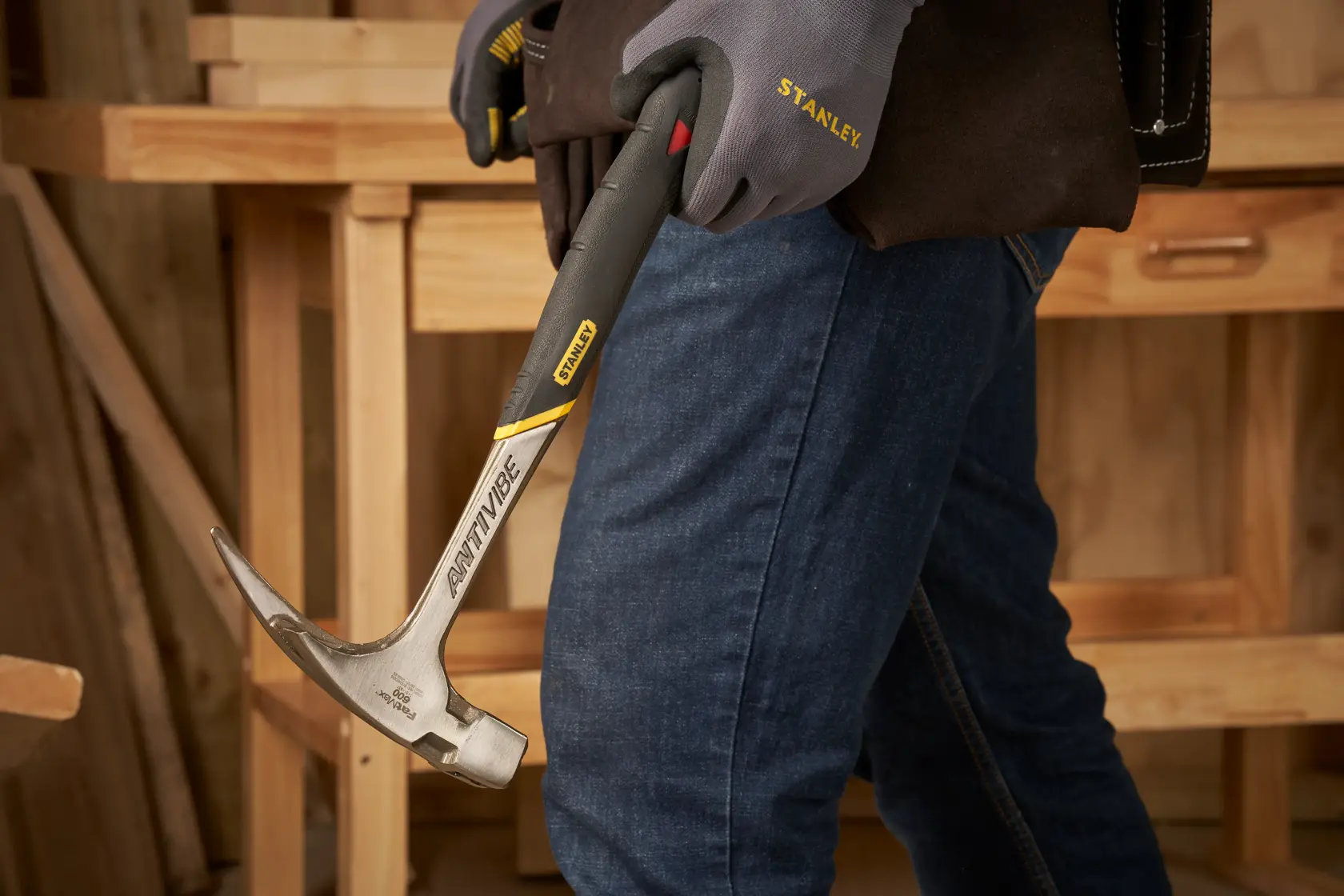 STANLEY 1-51-937 hammer with anti-vibe handle held in gloved hand in workshop setting.