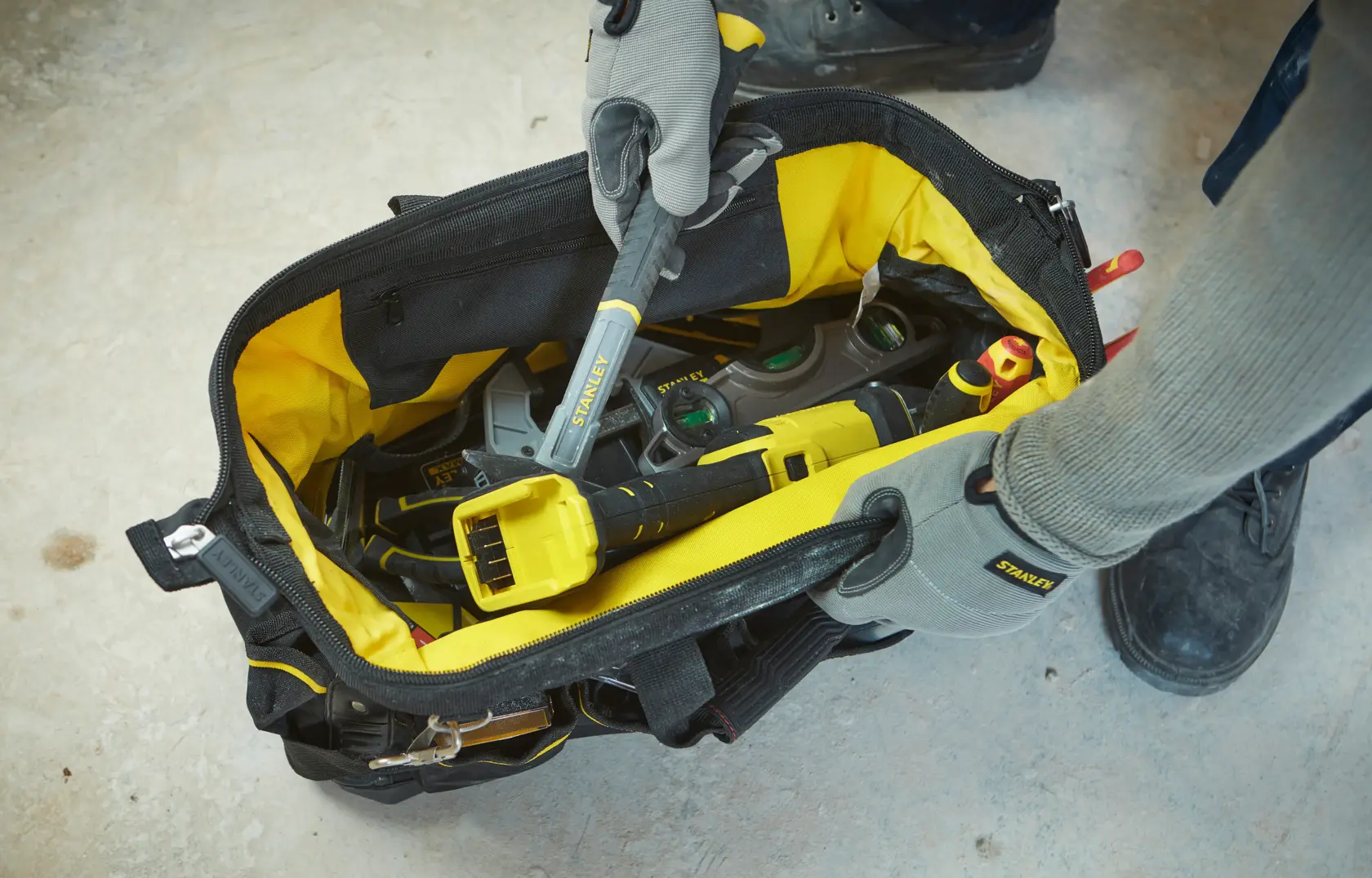 Photo of STANLEY 1-93-950 tool bag open, filled with assorted hand tools, viewed from above.