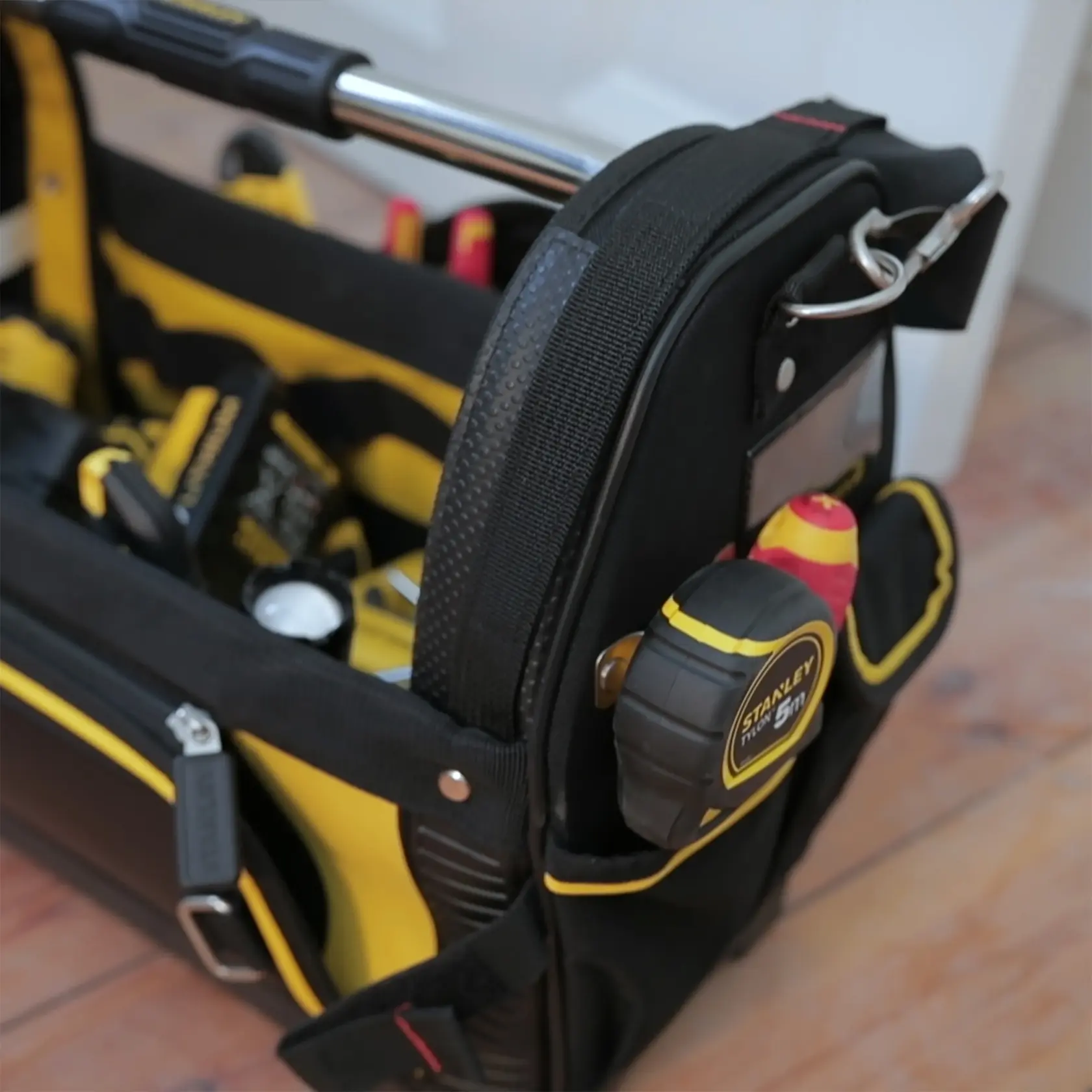 STANLEY 1-93-951 tool bag with yellow and black detailing, filled with tools, side pocket close-up.