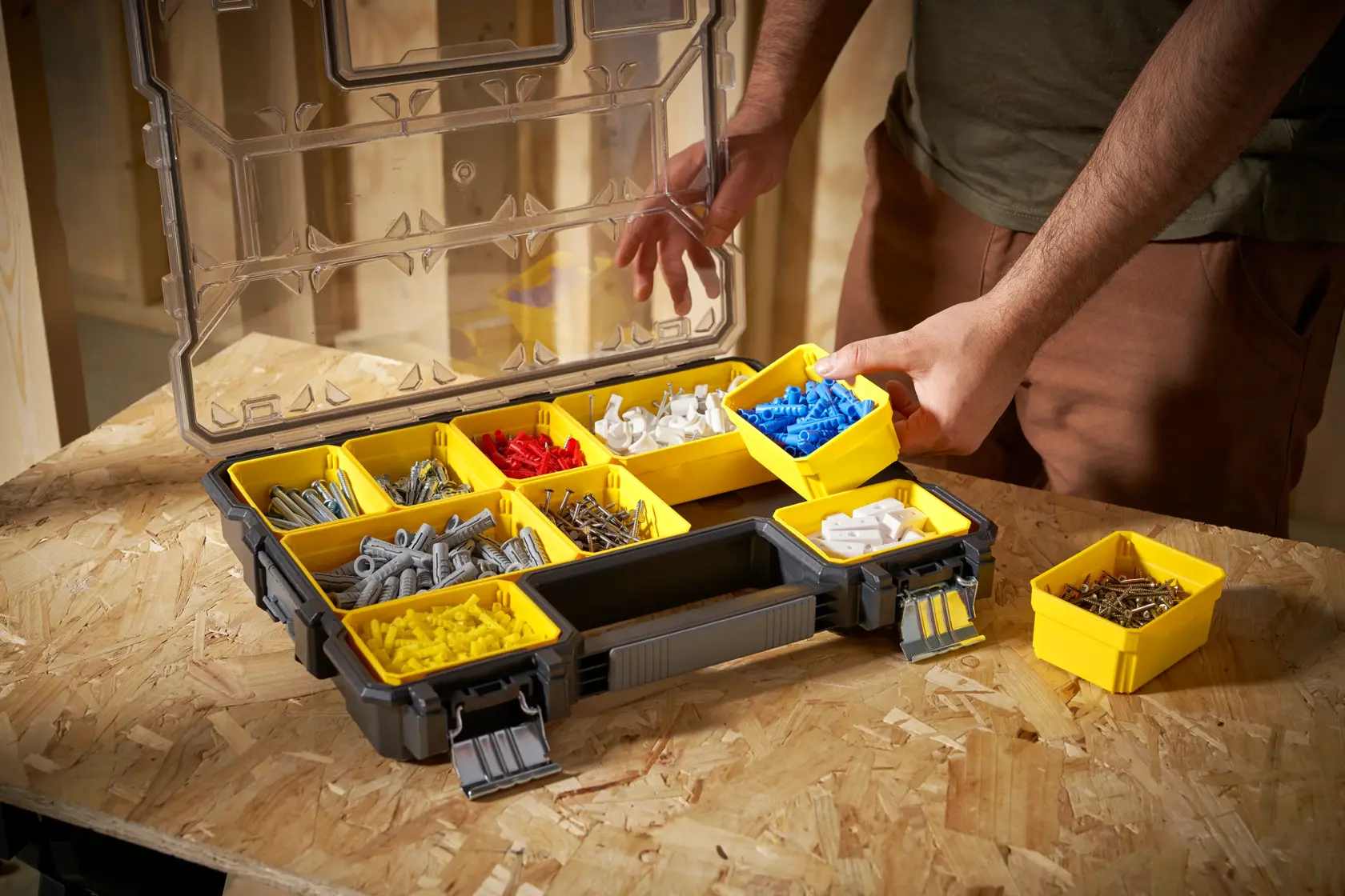 STANLEY 1-97-517 organizer with yellow removable bins filled with assorted fasteners, photo at workbench angle.