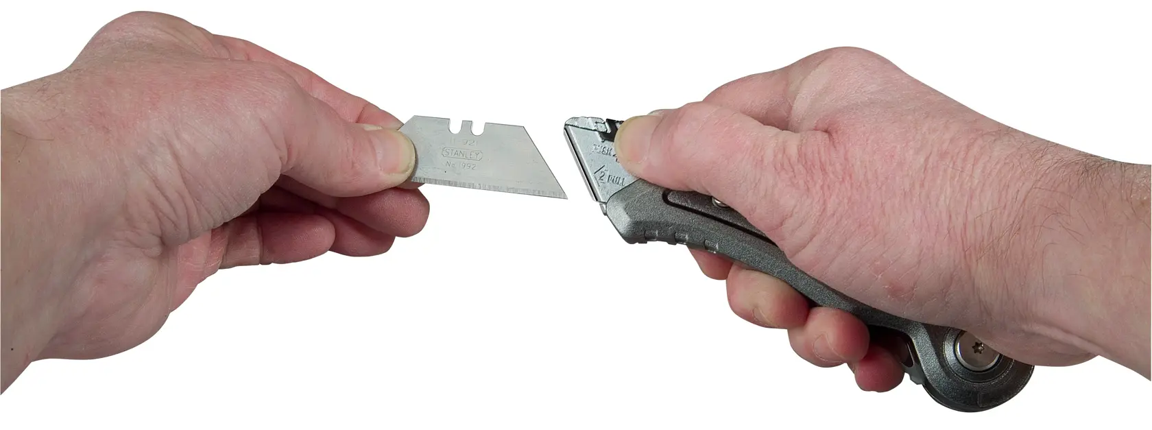 Photo of STANLEY 10-813 utility knife with blade being changed, close-up on hands, white background.