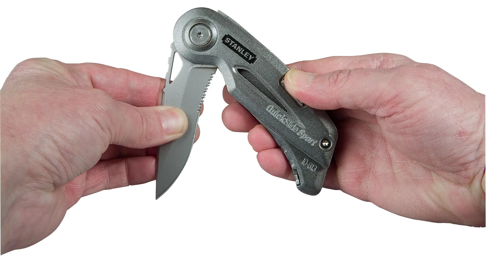 Photo of STANLEY 10-813 folding utility knife being opened by hand, showing metallic handle and partially serrated blade.