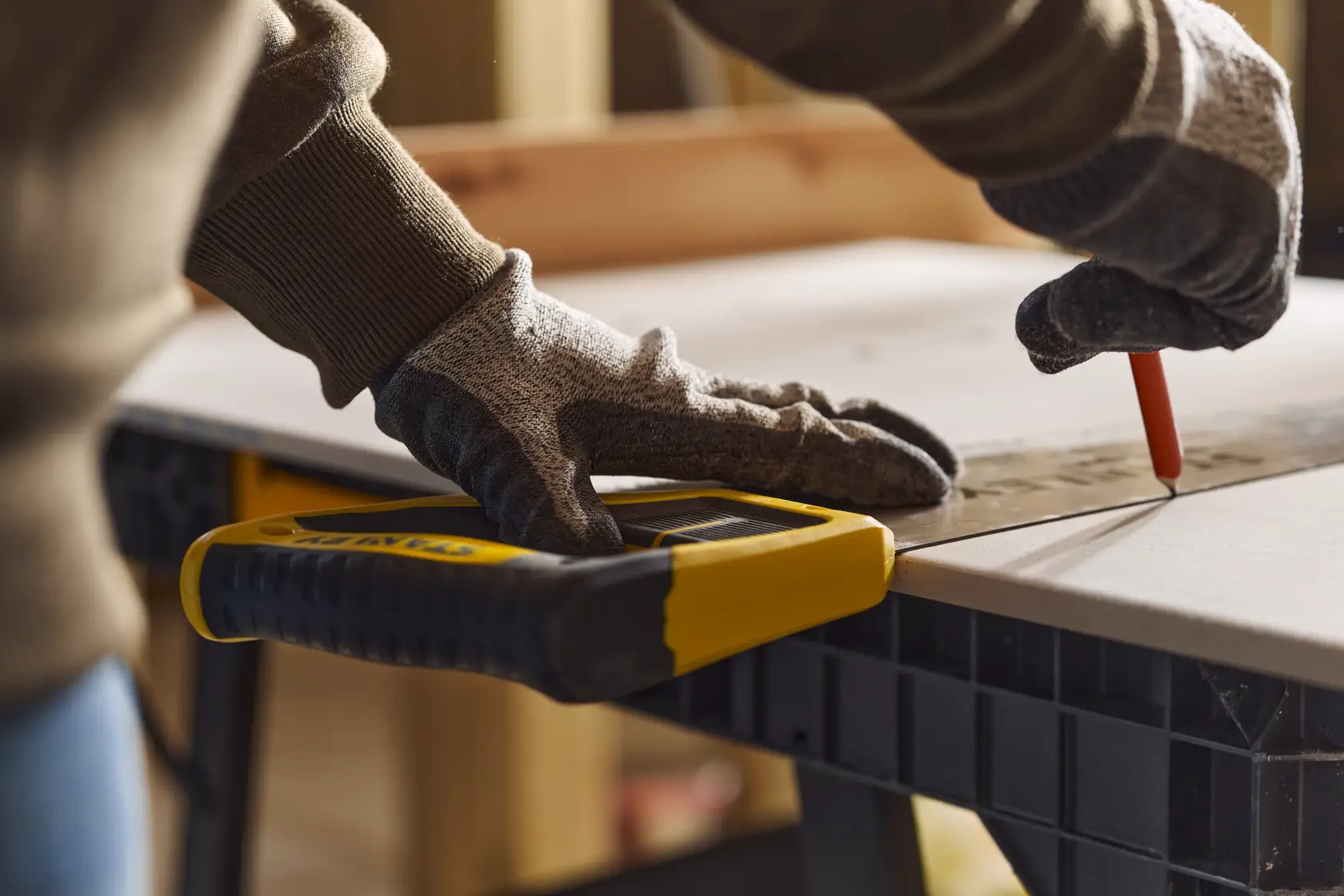 Photo of STANLEY 2-15-288 handsaw with yellow and black handle, used on a workbench for precise cutting.