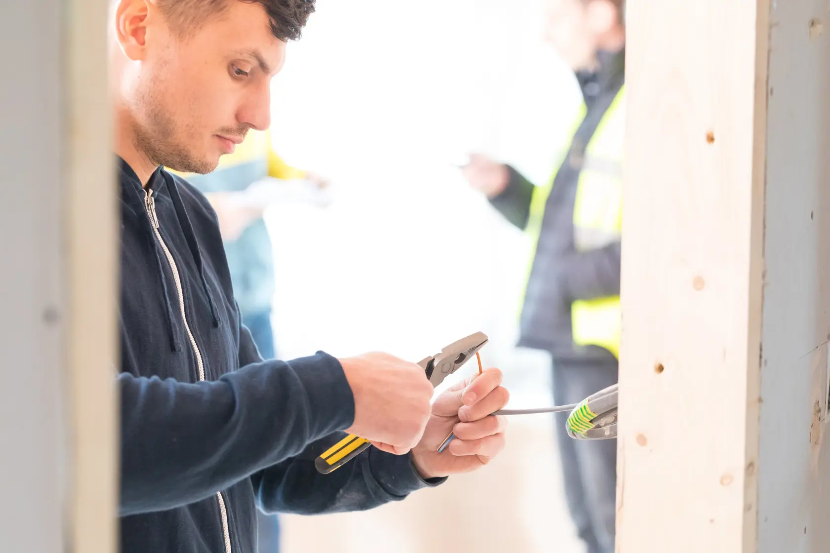 Photo of STANLEY 89-868 pliers used to grip wire during electrical installation on construction site.