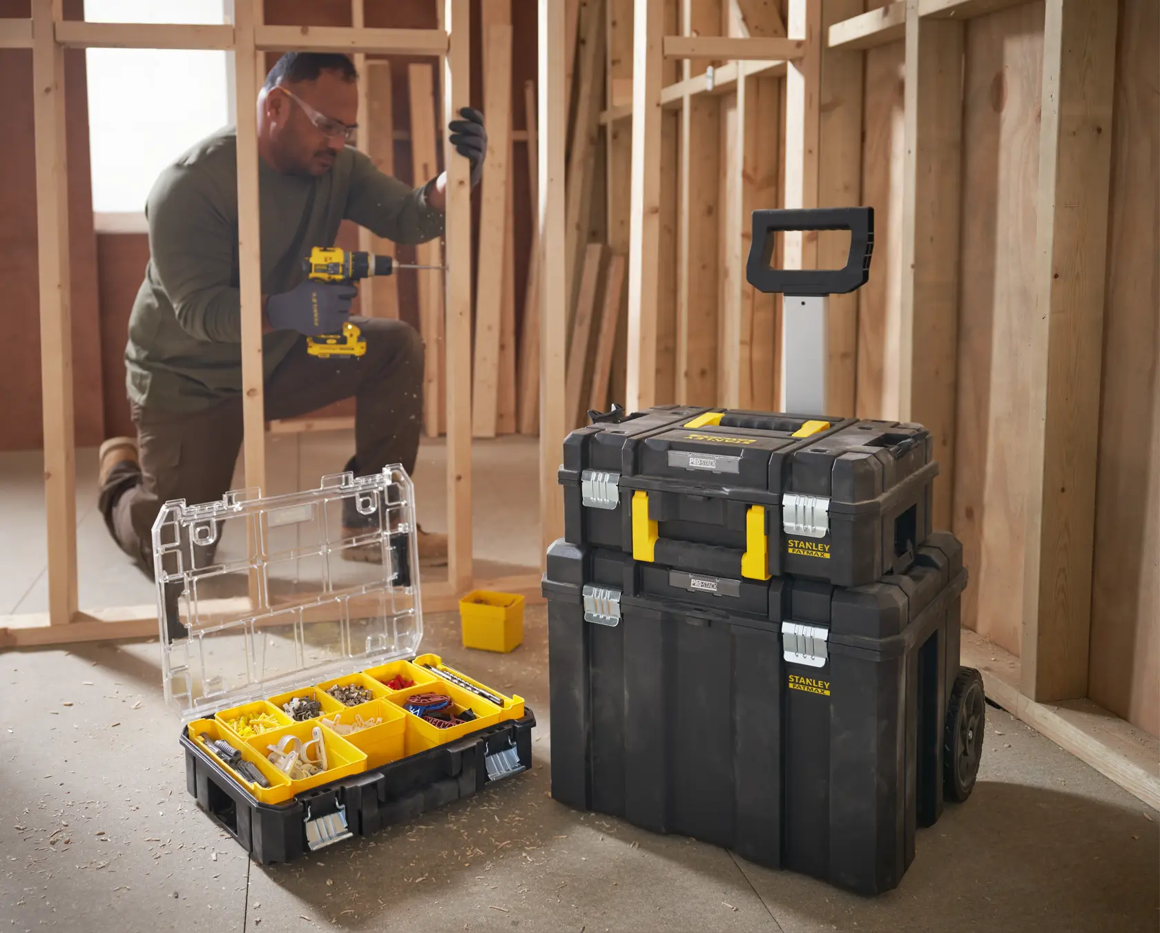 Photo of STANLEY FMST1-80101 modular toolboxes, including an open organizer and stackable rolling cases at a construction site.