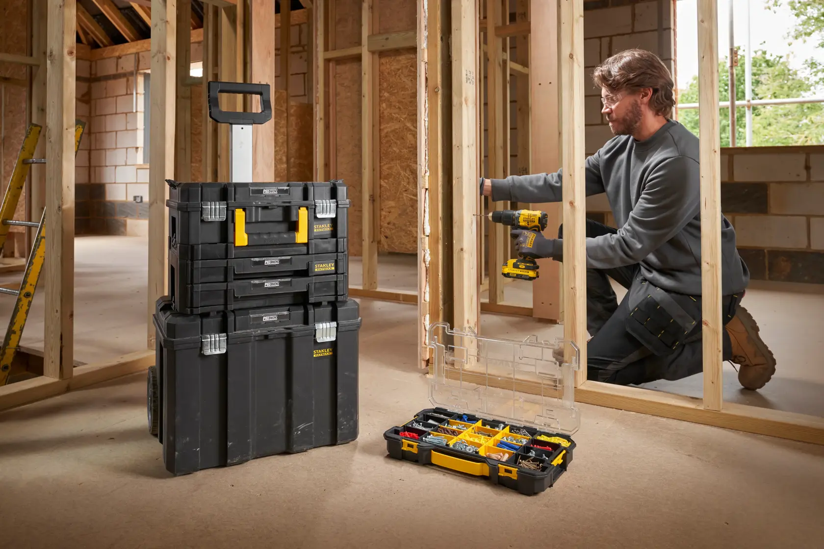 STANLEY FMST17838-1 modular black and yellow rolling toolbox stack and open organizer case on construction site.