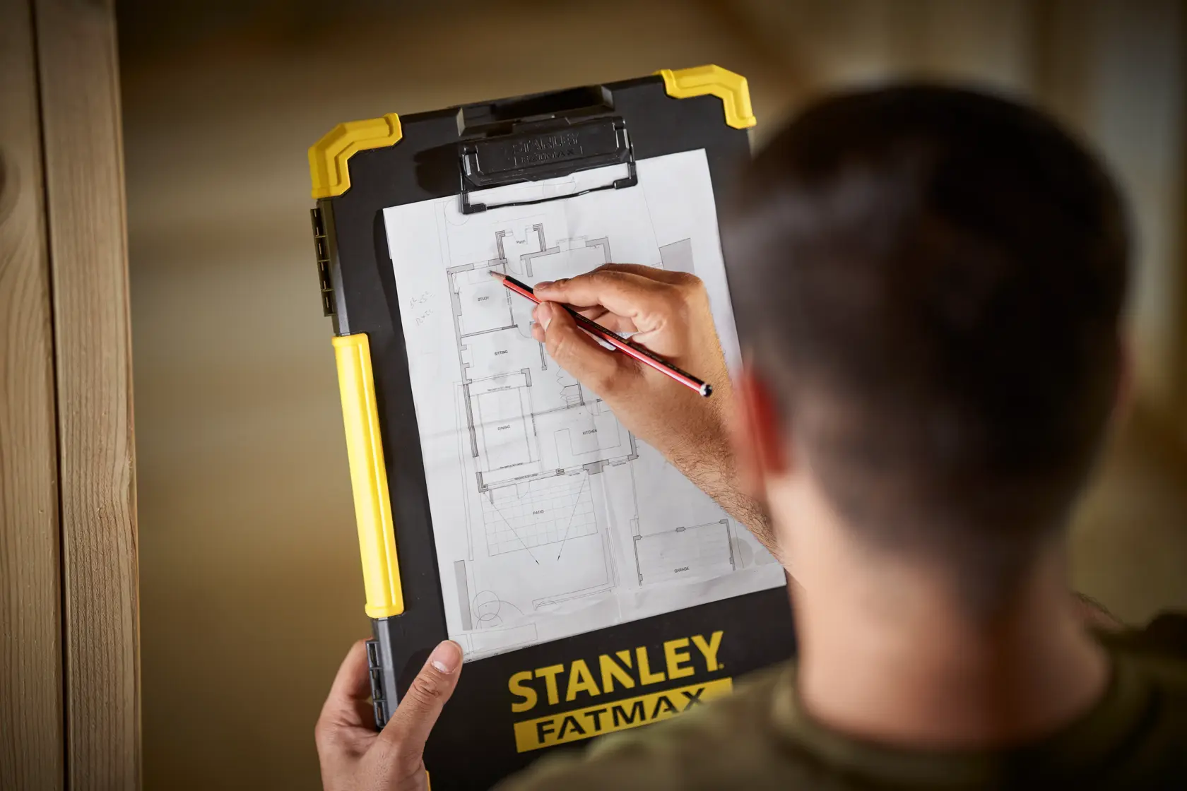 STANLEY FMST82721-1 clipboard with yellow handle, held by person marking architectural plan.