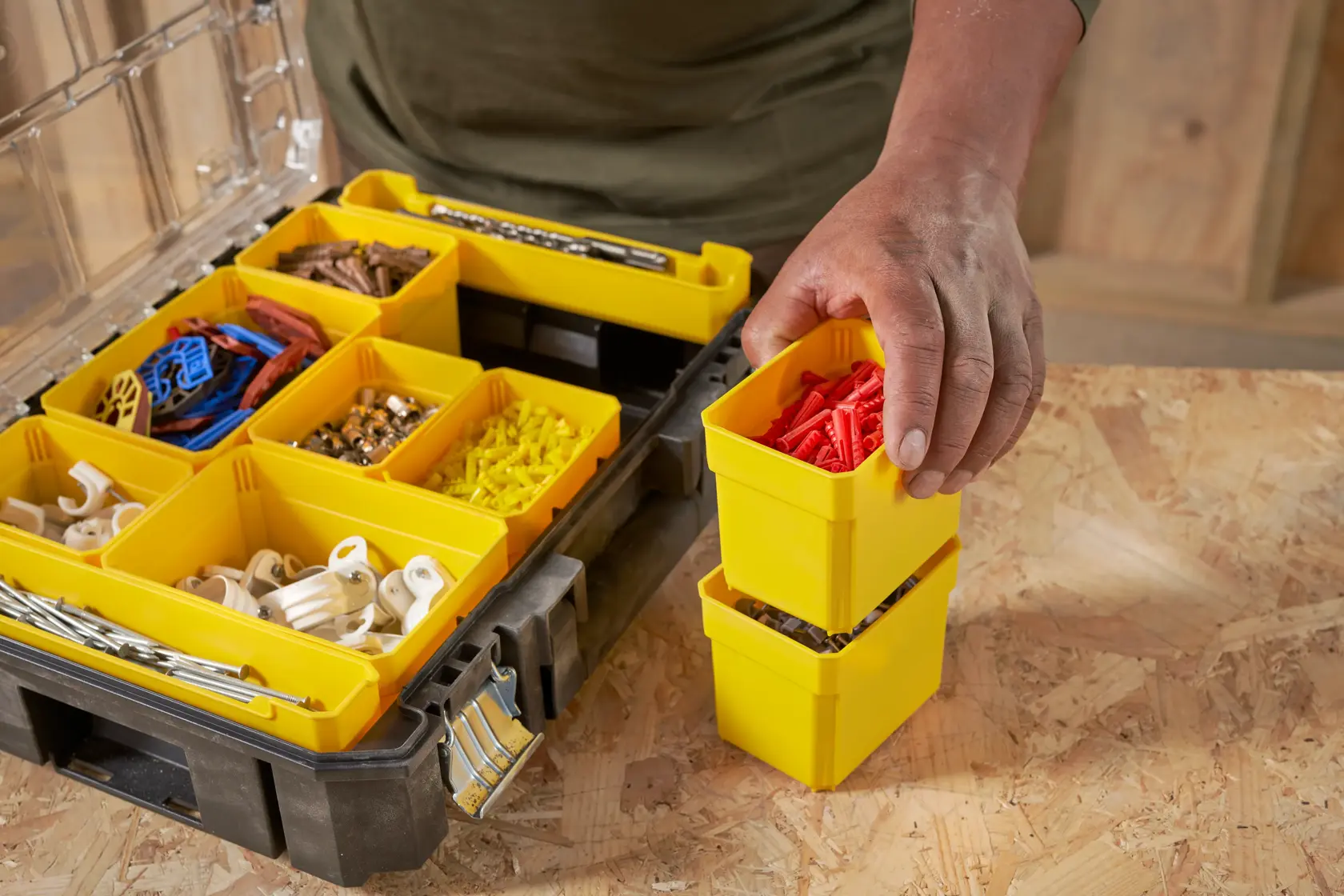 STANLEY FMST82967-1 organizer with yellow removable bins holding various hardware parts, close-up top view.