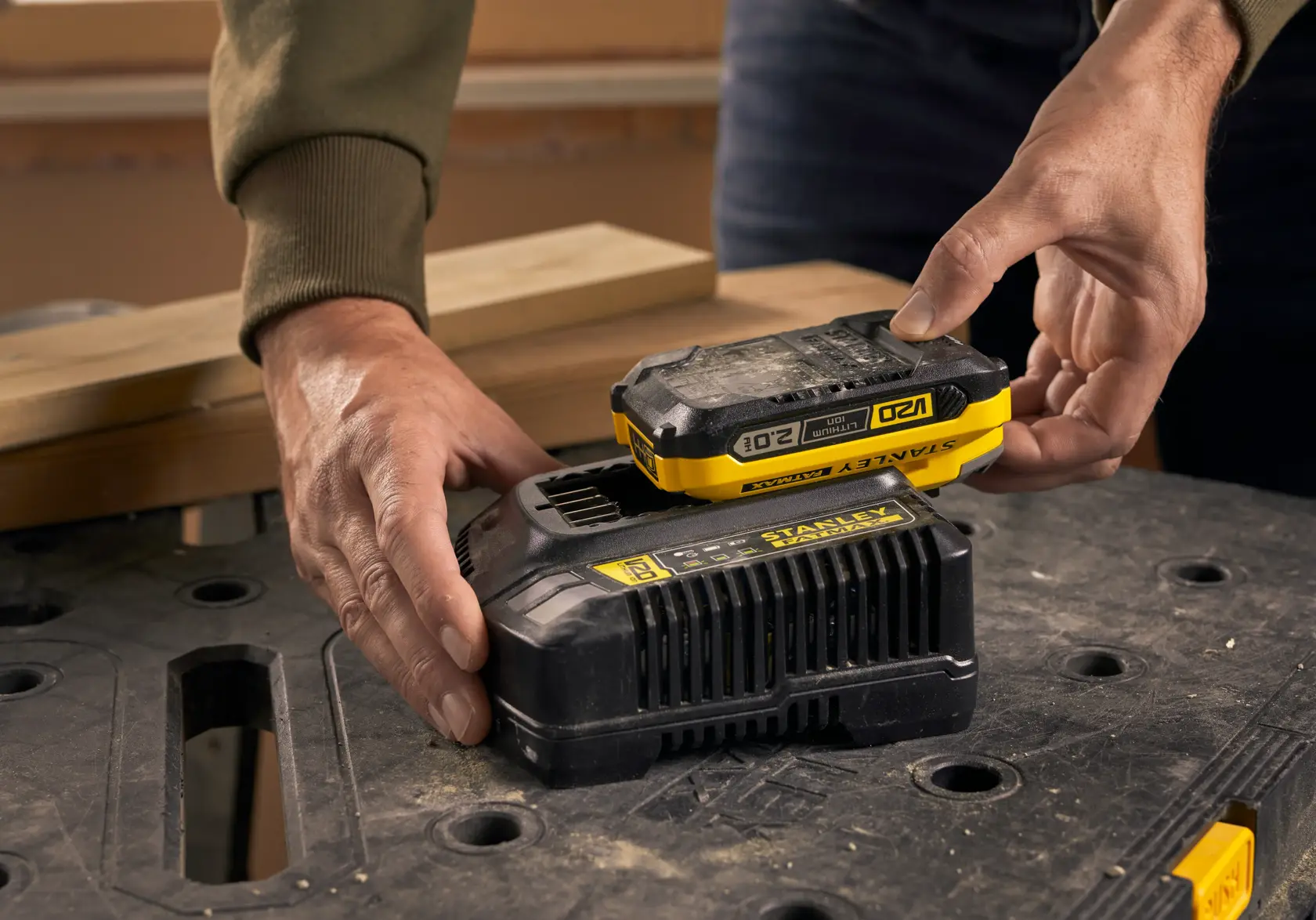 STANLEY SFMCB12D2 battery pack and charger, close-up on workbench.