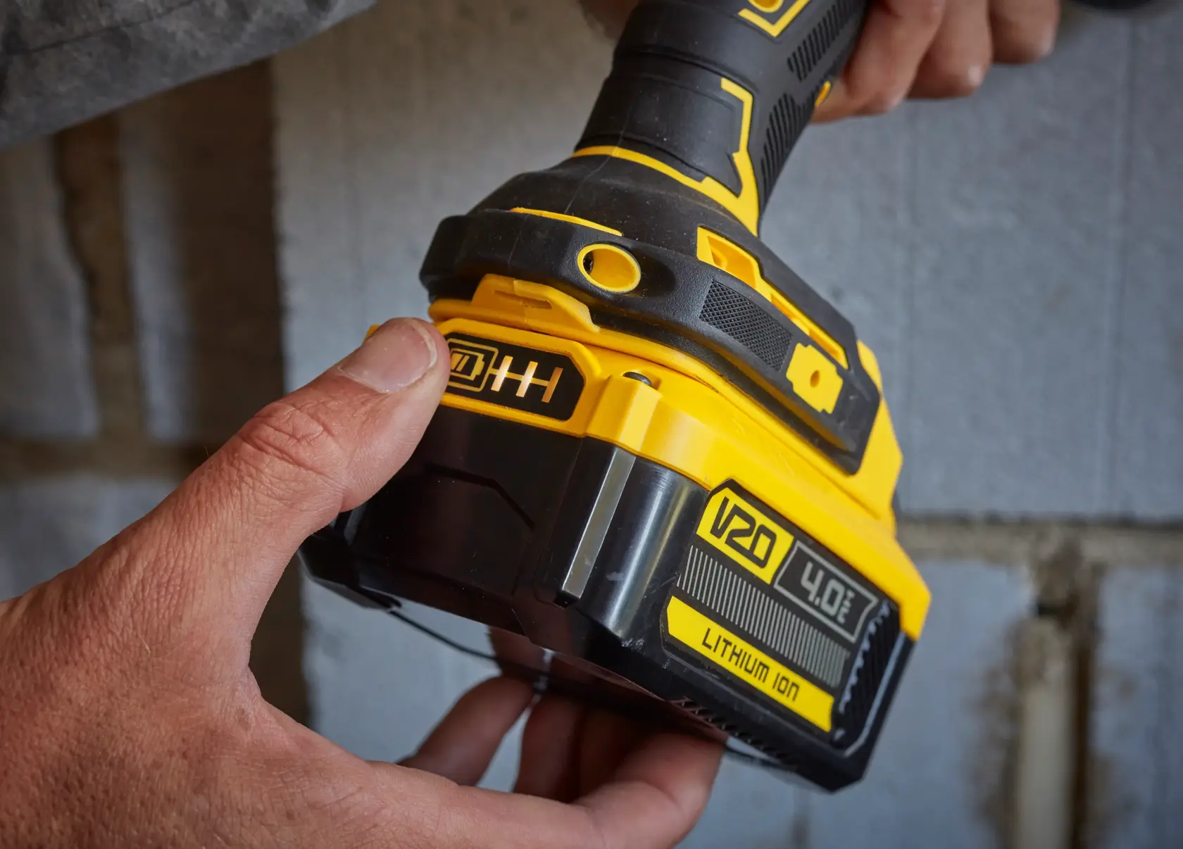 STANLEY SFMCB204 lithium ion battery pack close-up on a power tool, yellow and black, side angle.