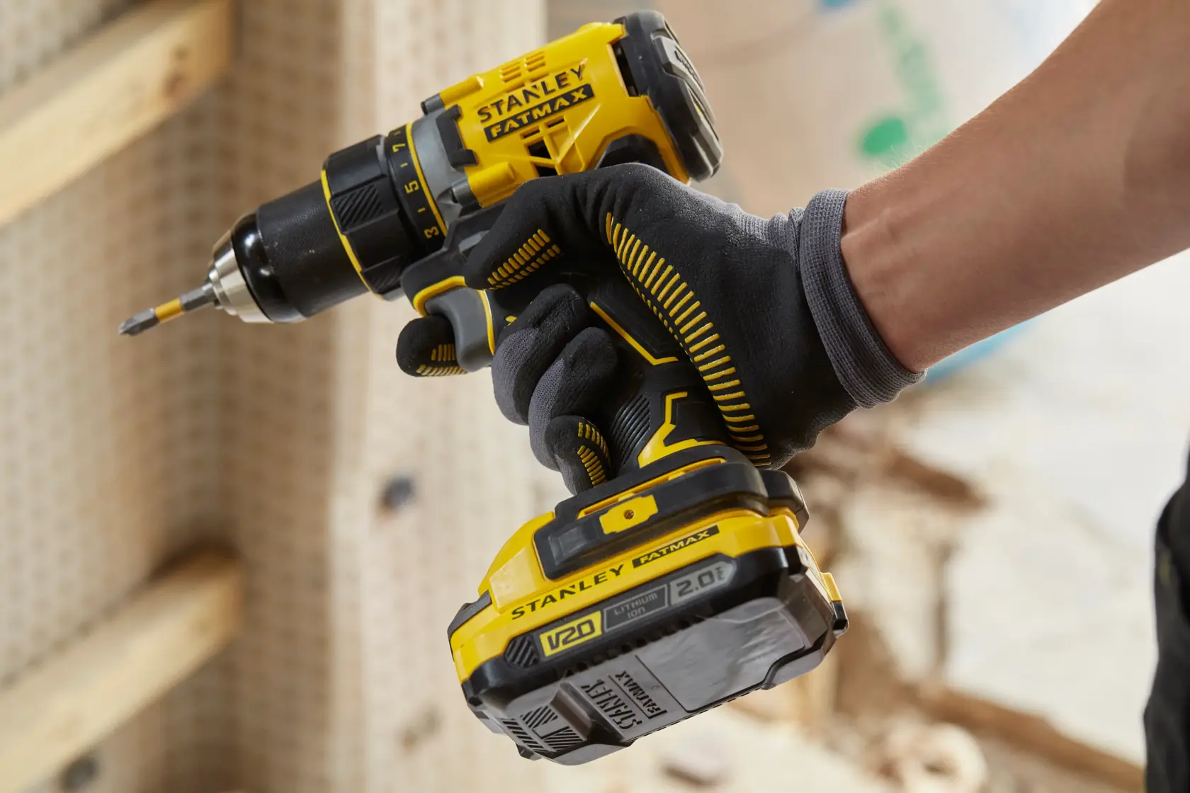 STANLEY SFMCD720B cordless drill in use, yellow and black design, close-up side angle.