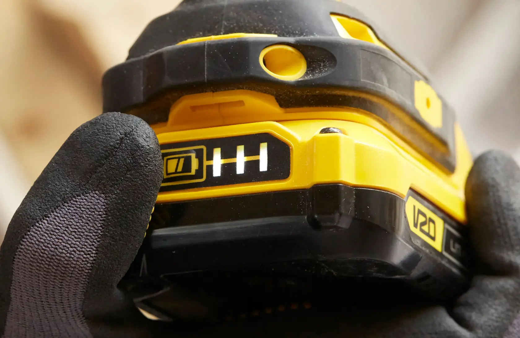 STANLEY SFMCF820D2K V20 power tool battery with charge indicator close-up, photography.