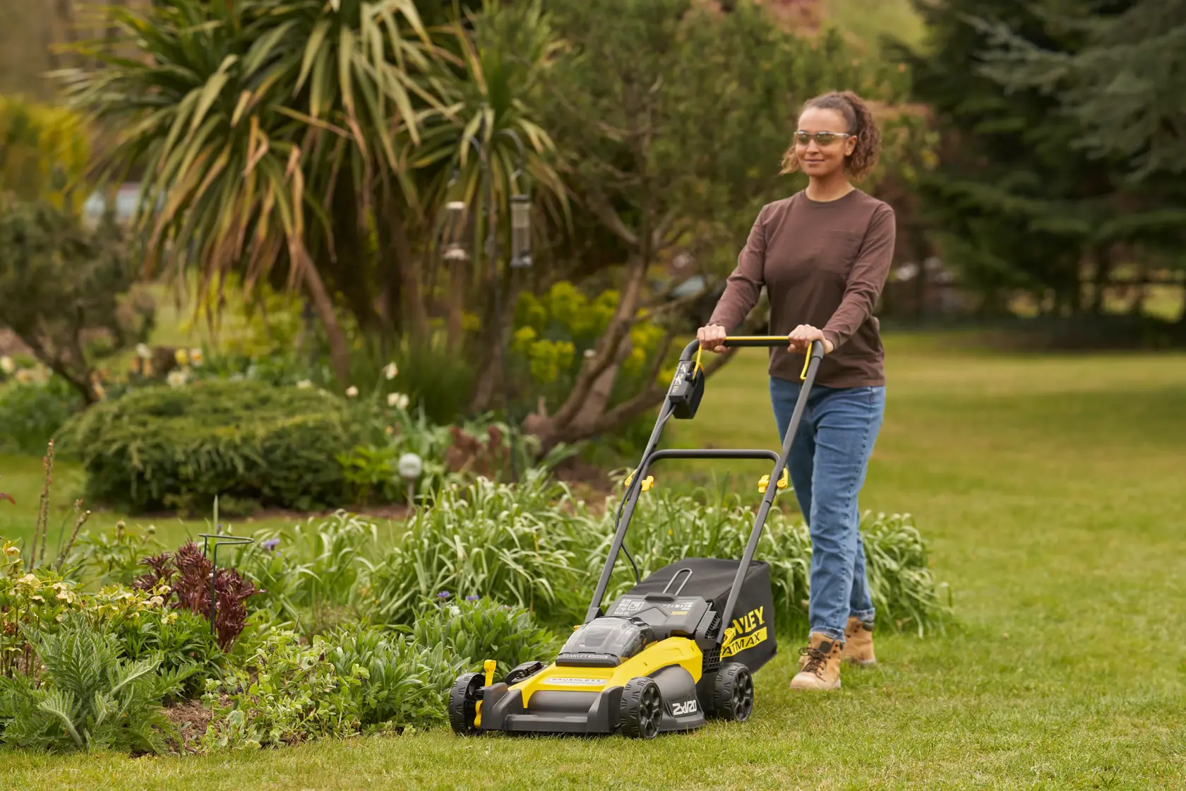 STANLEY SFMCMW2651M lawn mower in use outdoors on grass, yellow and black design, side view.