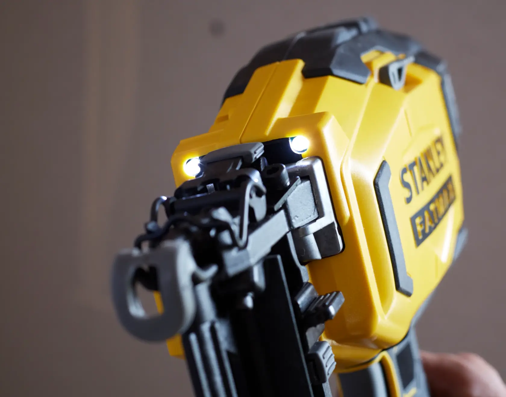 STANLEY SFMCN616B cordless nailer close-up showing LED lights and yellow housing.