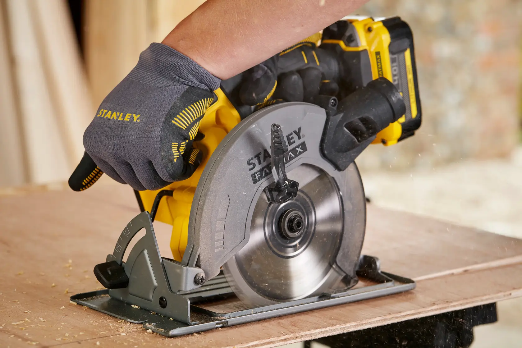 STANLEY SFMCS500B circular saw in use, yellow and gray design, cutting wood.