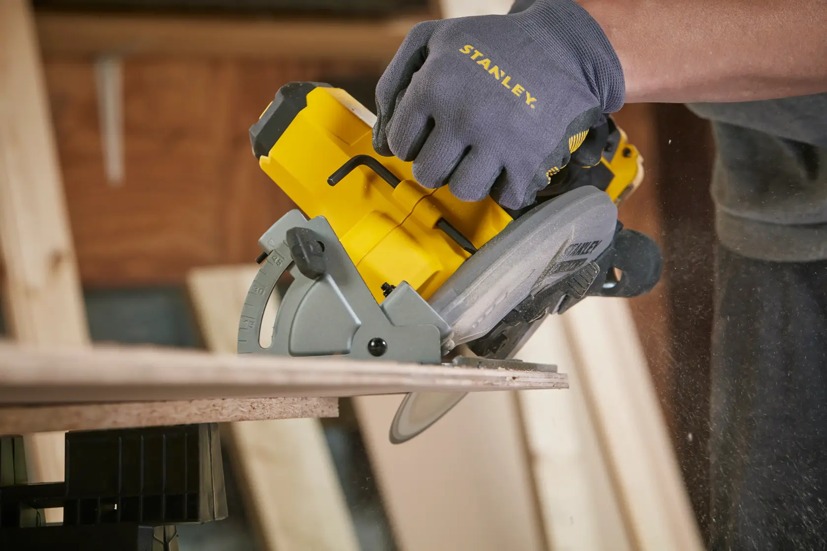 Stanley SFMCS500B circular saw in use, cutting wood, close side view, yellow and gray tool.