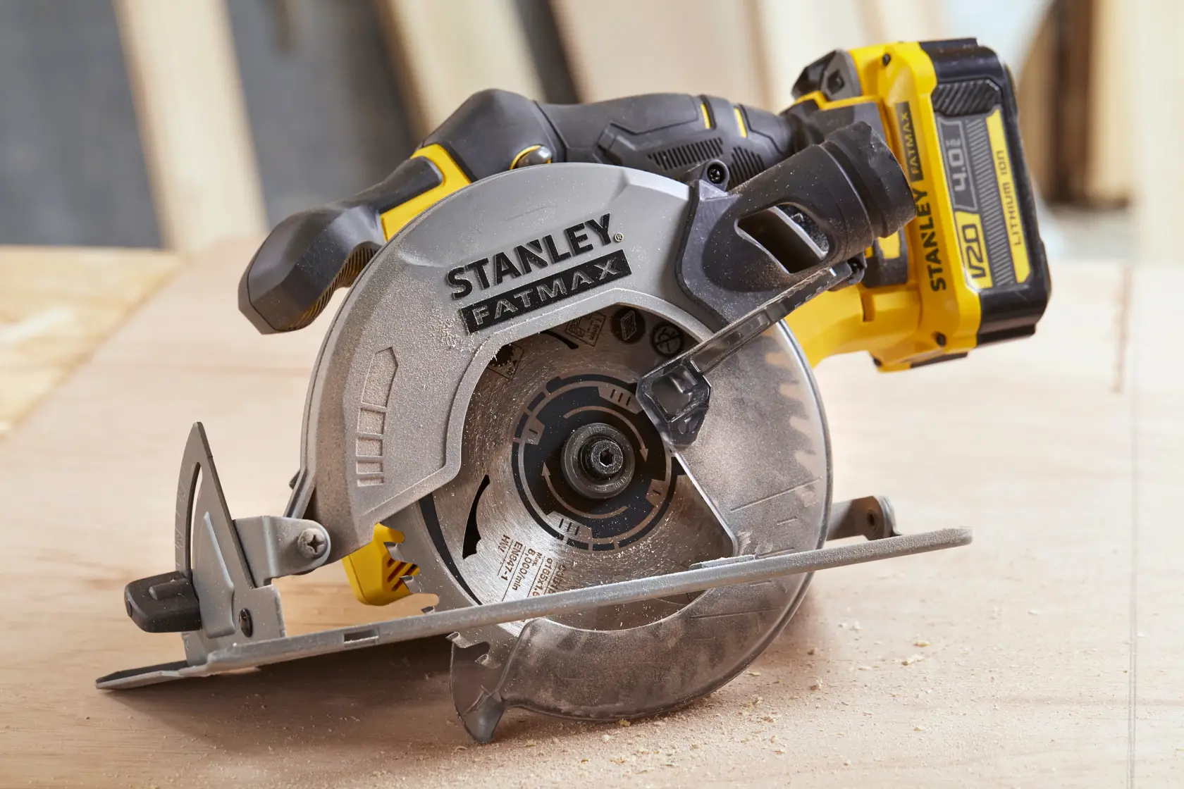 STANLEY SFMCS500B cordless circular saw, side angle, yellow and black, in use on wood surface