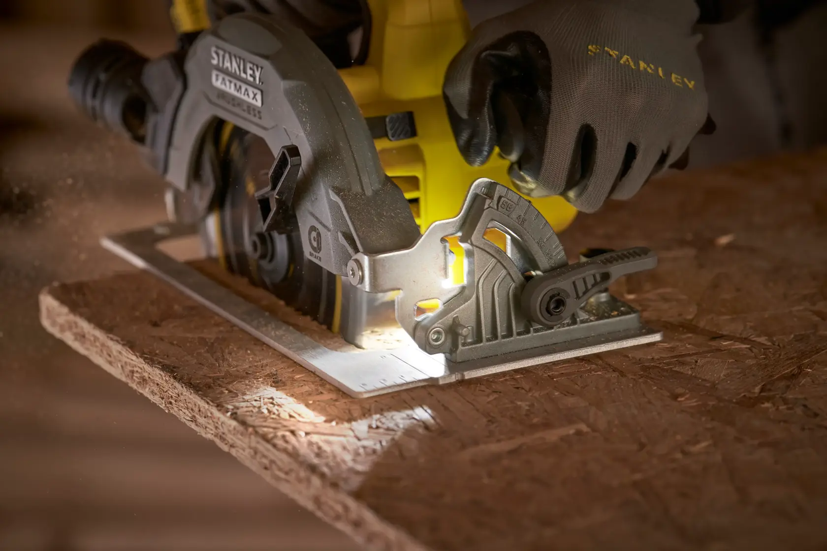 STANLEY SFMCS550B circular saw cutting wood, close-up view with gloved hand operating tool.