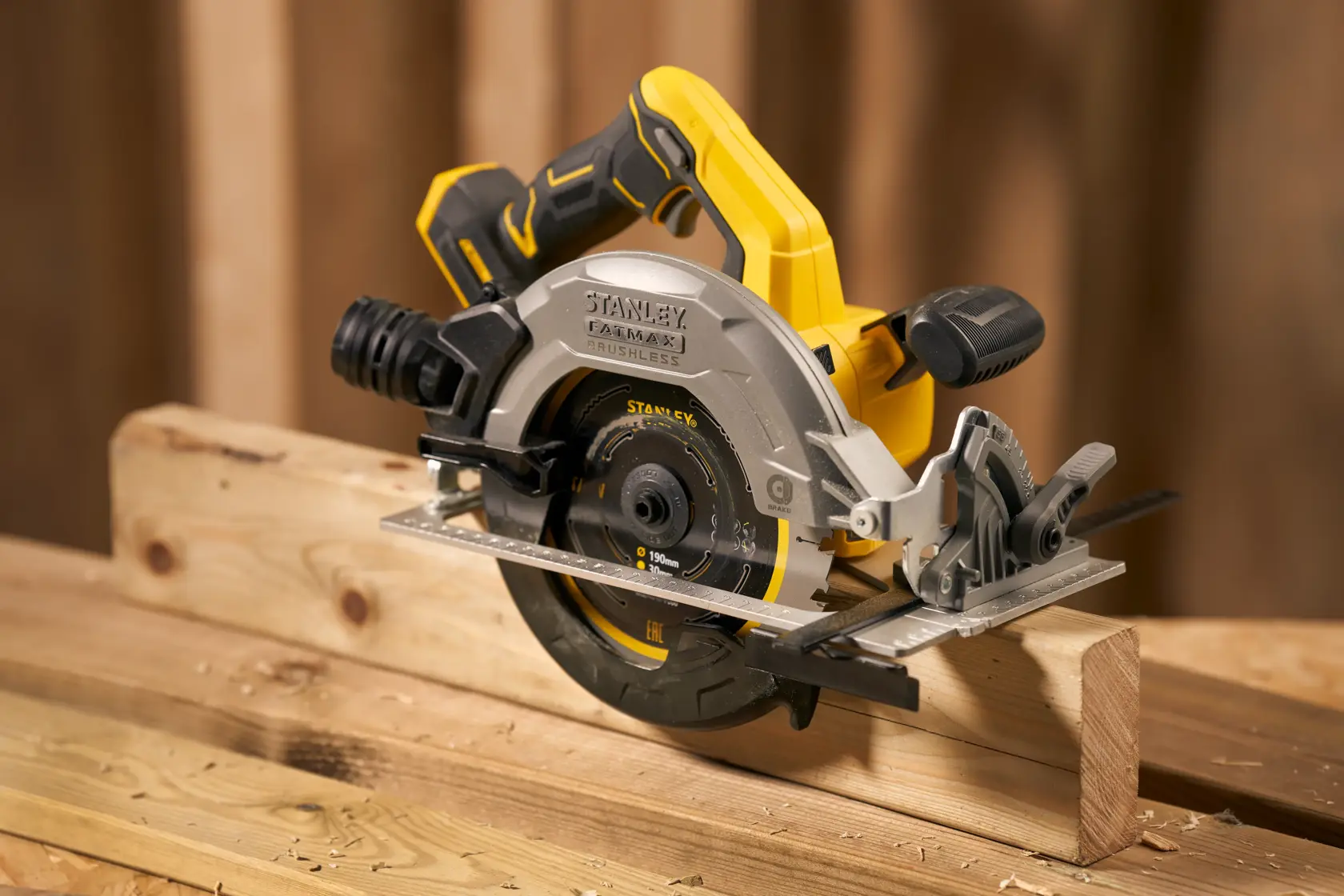 STANLEY SFMCS550M2K cordless circular saw with brushless motor cutting wood, side angle view.