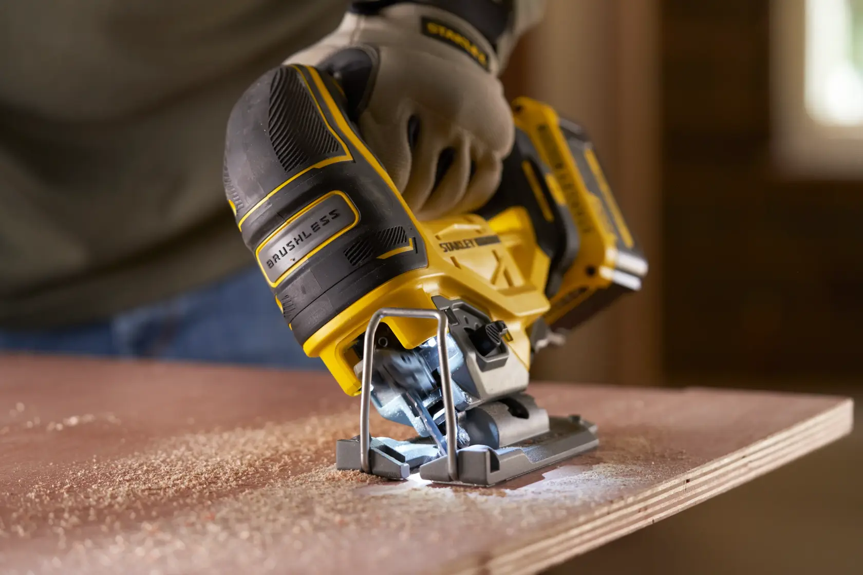Photo of STANLEY SFMCS650B 18V FATMAX V20 brushless jigsaw cutting wood, close-up, tool in use.