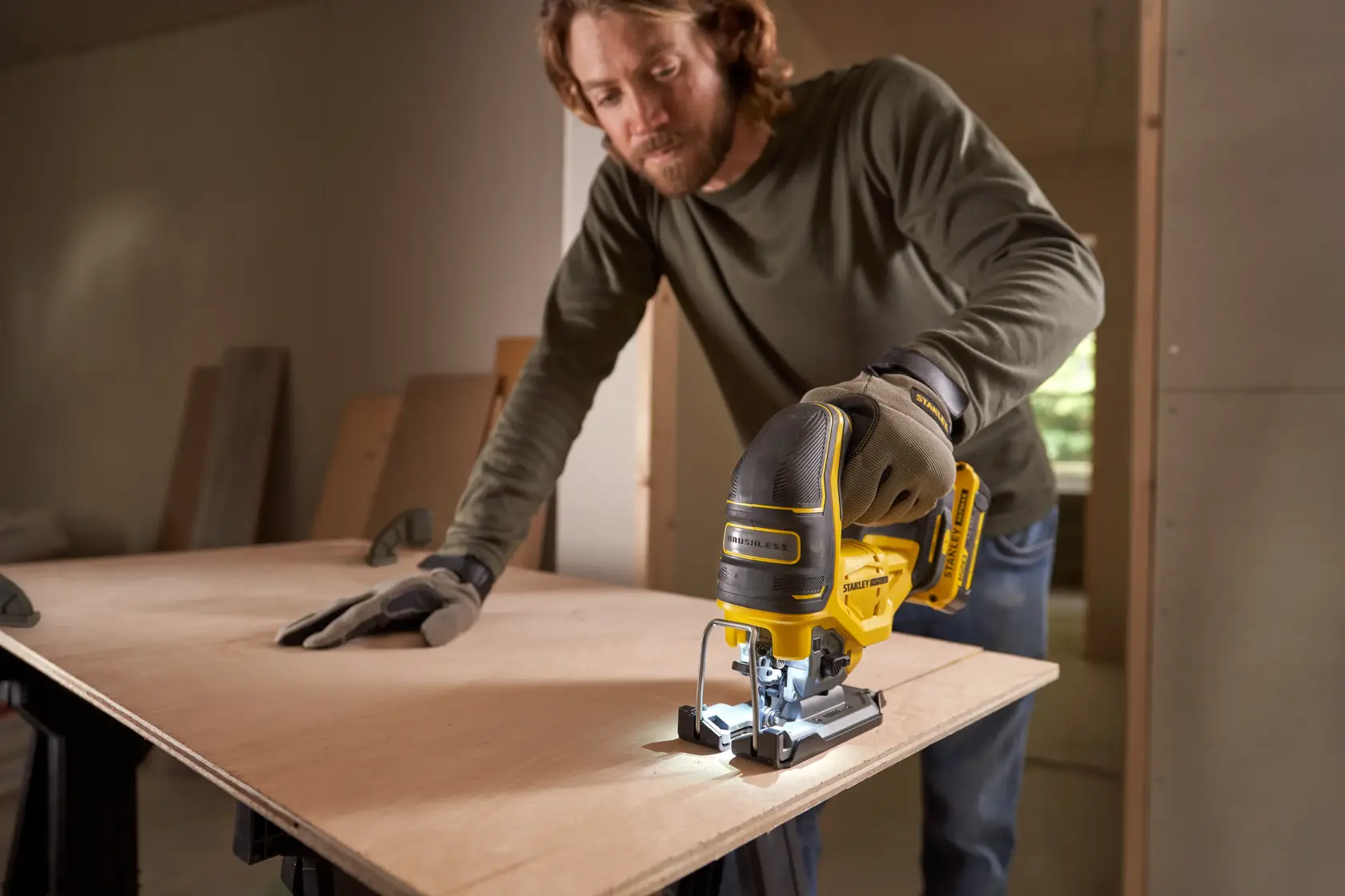 STANLEY SFMCS650B 18V STANLEY FATMAX V20 Brushless Jigsaw in use cutting wood, product close-up in workshop.
