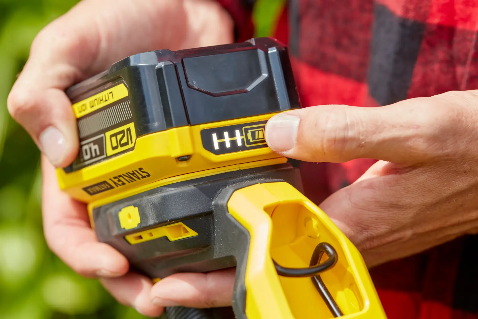 Photo of STANLEY SFMCST933M1 battery-powered tool being operated, yellow and black details visible.
