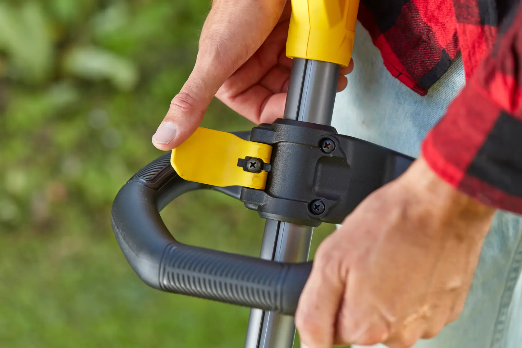 STANLEY SFMCSTB933B close-up of adjustable handle grip on outdoor power tool, photography from side angle.