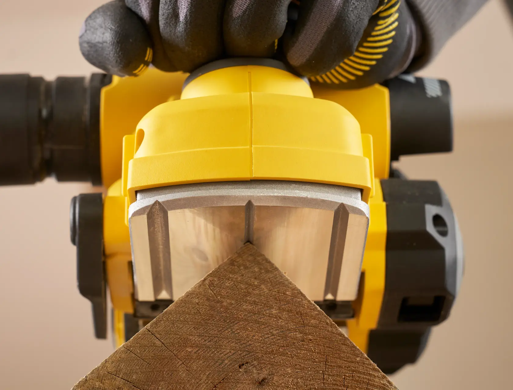 STANLEY SFMCW300B planer close-up smoothing wood corner, shown from front in use.