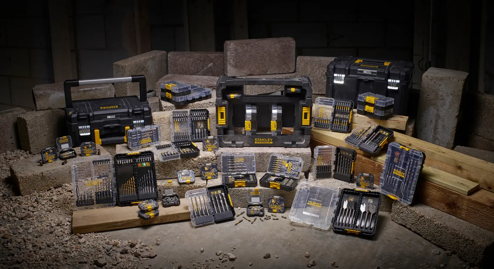 STANLEY STA88558 toolkit set with drill bits, cases, and toolboxes arranged on construction site.