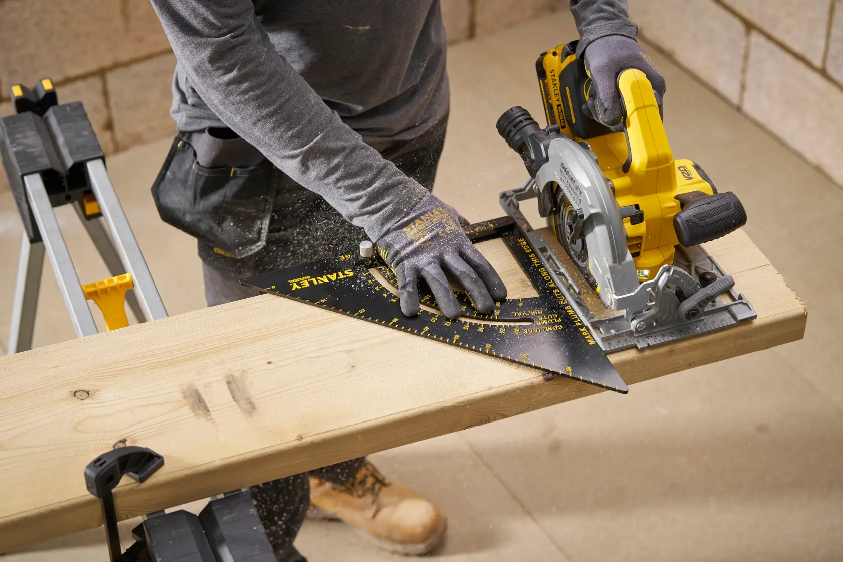 STANLEY STHT46055-0 carpenter's square being used to guide a circular saw on a wooden board, workshop setting.