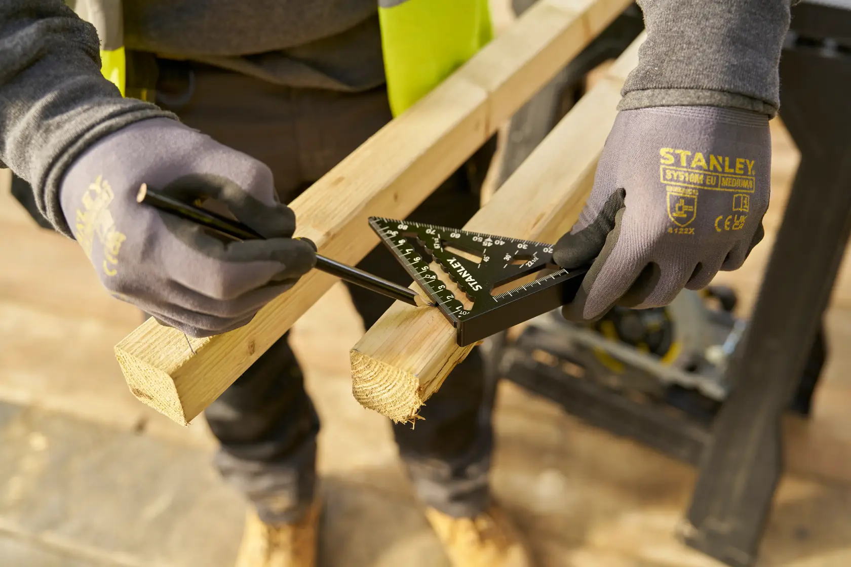 STANLEY STHT46100-0 rafter square used to measure and mark a wooden beam, worker wearing gloves.