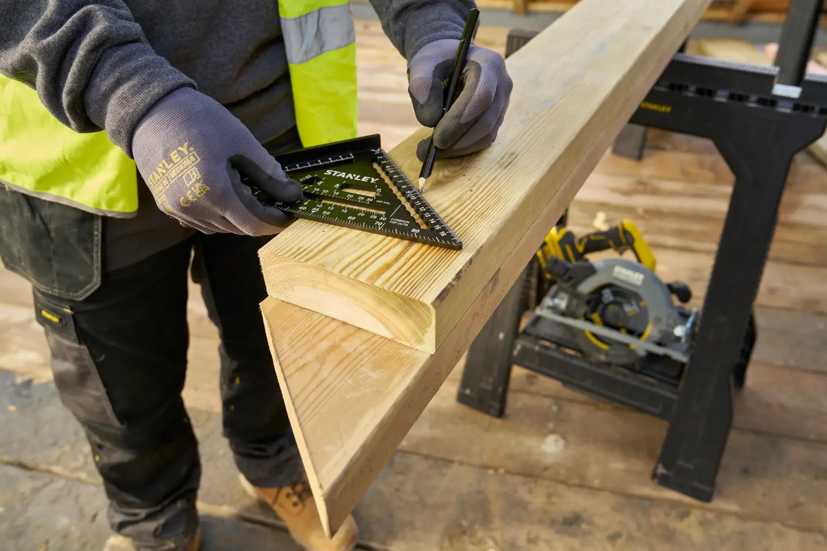 STANLEY STHT46101-0 carpenter's square marking wood on job site, close-up photography.