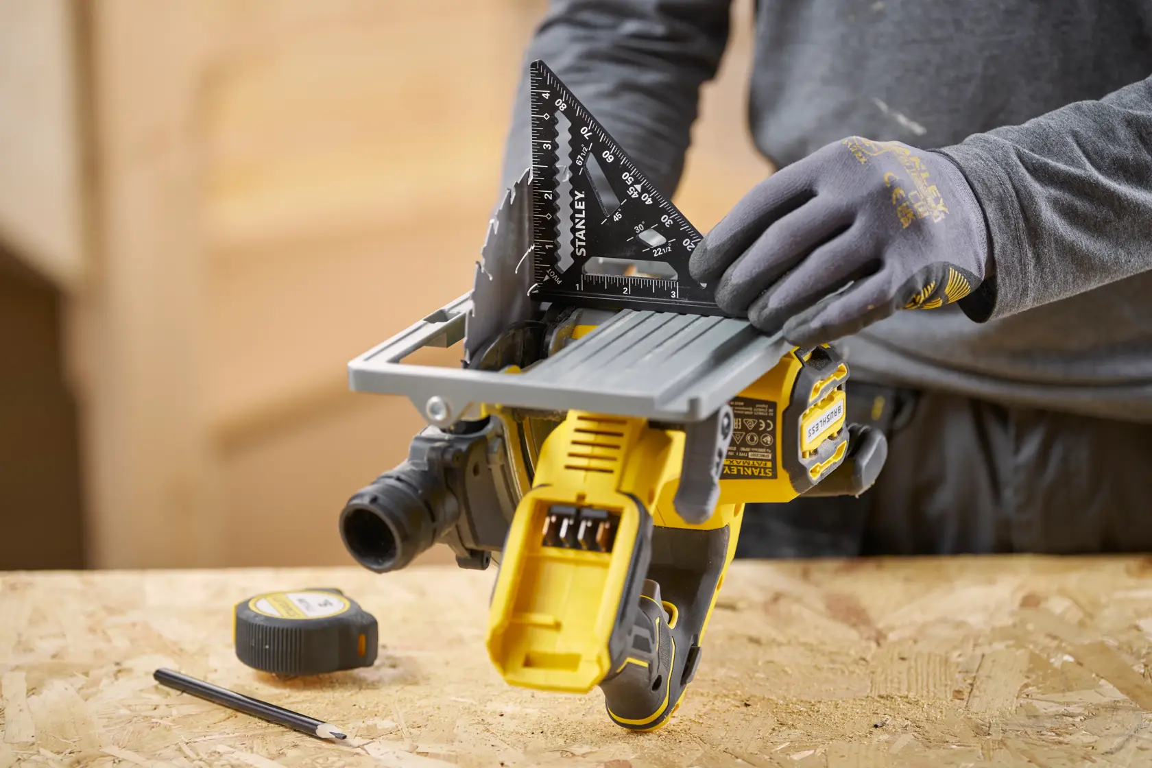 STANLEY STHT46103-0 black rafter square in use on a table saw, shown in workshop setting.