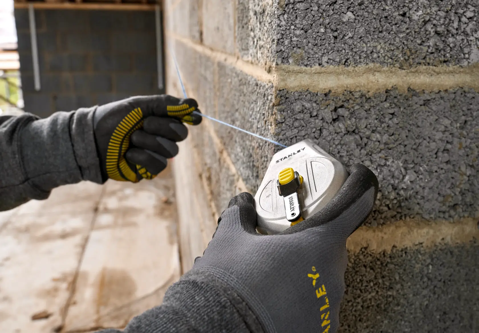 Stanley STHT47110-0 chalk reel photography showing use on concrete wall.