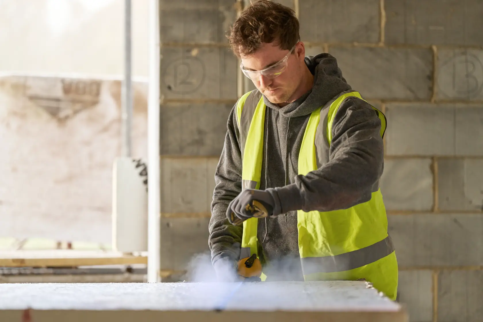 STANLEY STHT47112-0 hand tool in use on construction site, person in reflective vest holding and operating tool.
