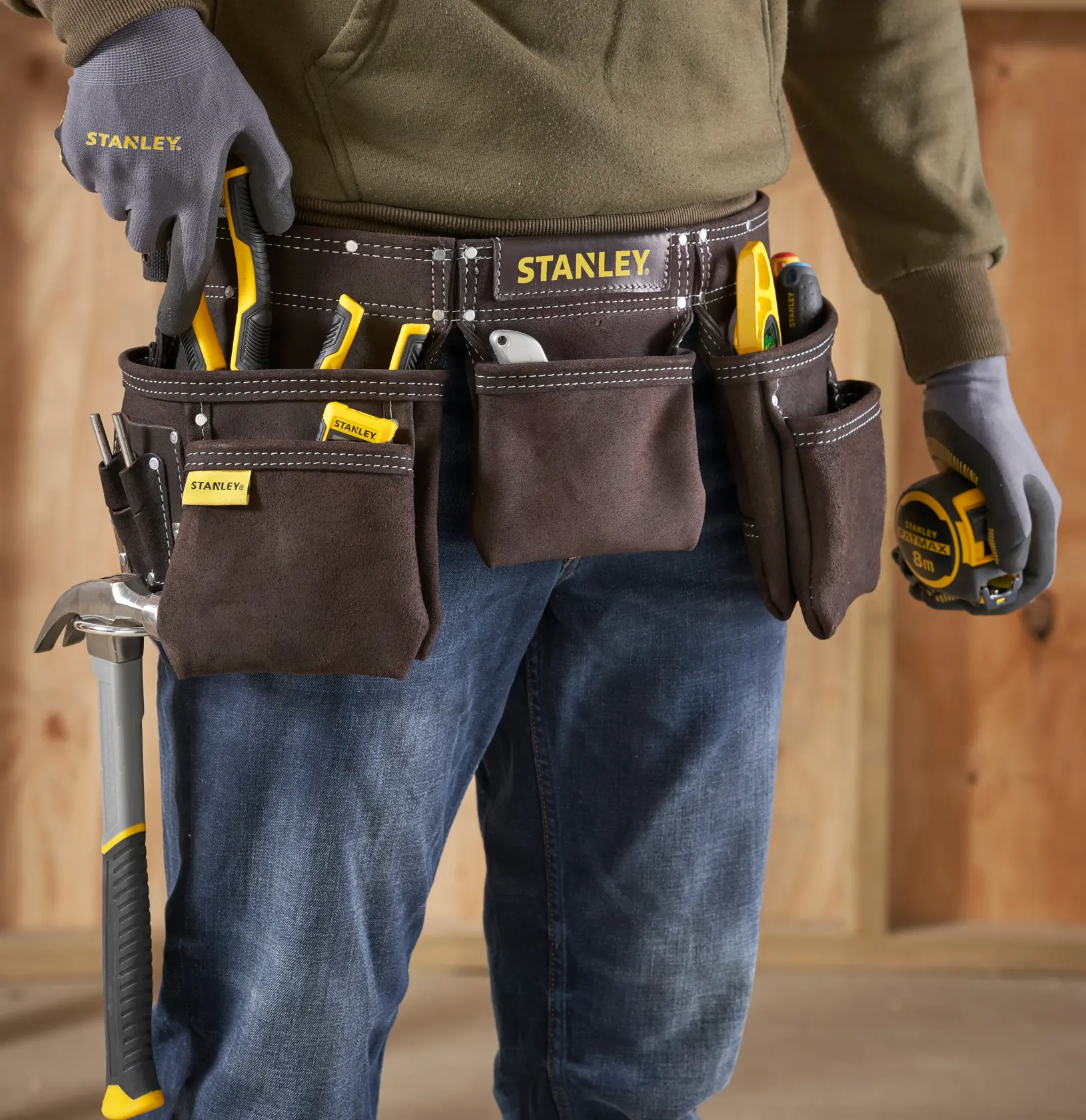 STANLEY STST1-80113 tool belt photography, brown suede belt with multiple pockets and hand tools being worn.