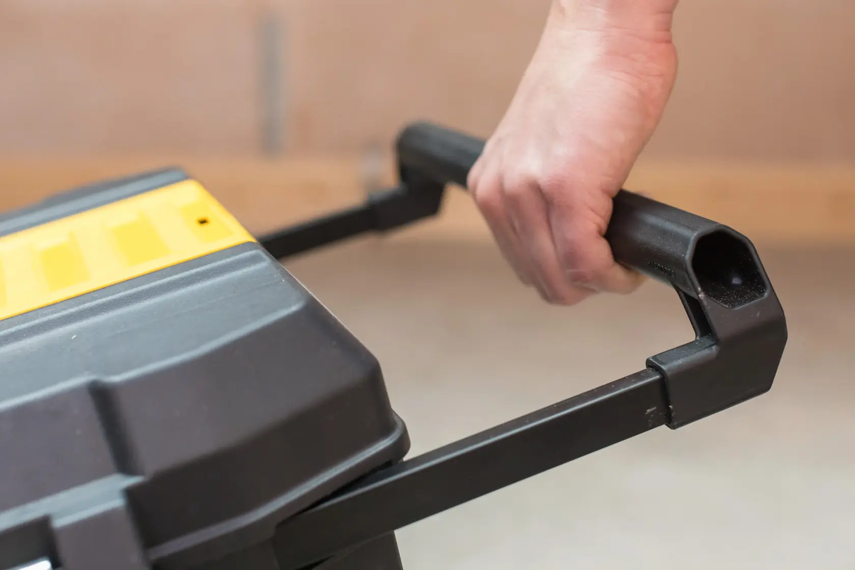 STANLEY STST1-80150 toolbox close-up showing black handle being gripped, photo of product in use.