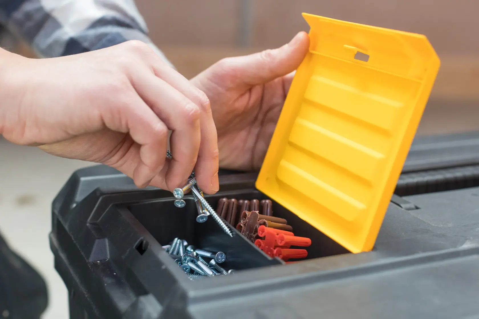 STANLEY STST1-80150 toolbox with open yellow lid, showing screws and wire connectors inside compartment.