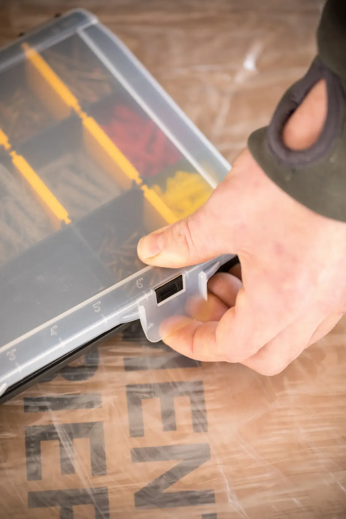 STANLEY STST81680-1 small parts organizer with clear lid, yellow dividers, hand opening latch, angled view.