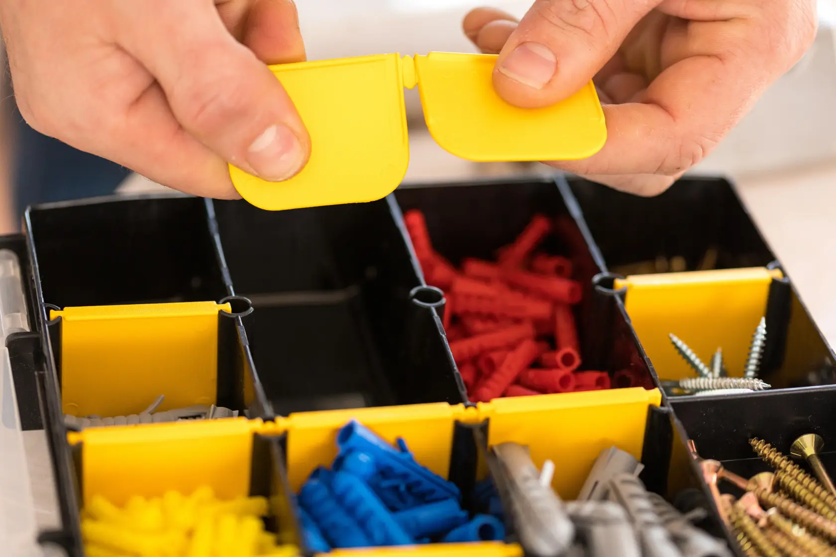 STANLEY STST81681-1 organizer box photography, yellow compartment lids, assorted screws and wall plugs.